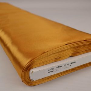Goud satijn stof op rol